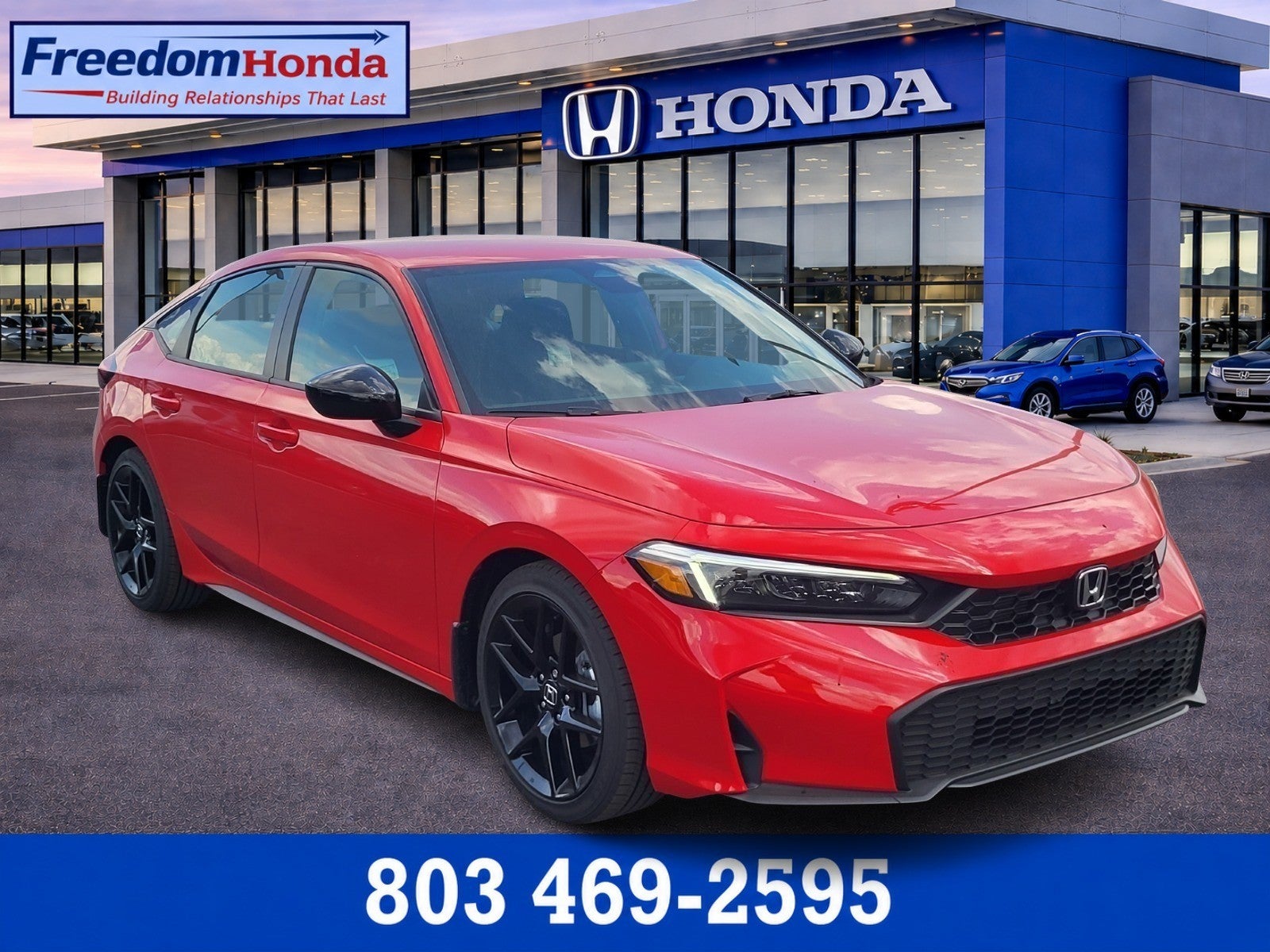 2026 Honda Civic Hatchback Sport in Rallye Red — front three-quarter view